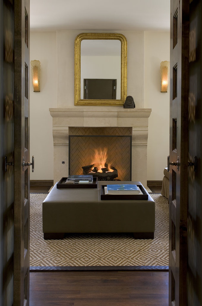 Photo of a traditional living room in Austin with a standard fireplace and white walls.