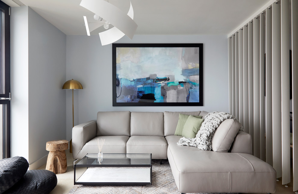 This is an example of a contemporary living room in London with blue walls.