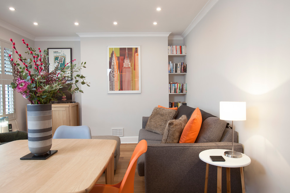 Photo of a small contemporary open plan living room in London with light hardwood flooring.