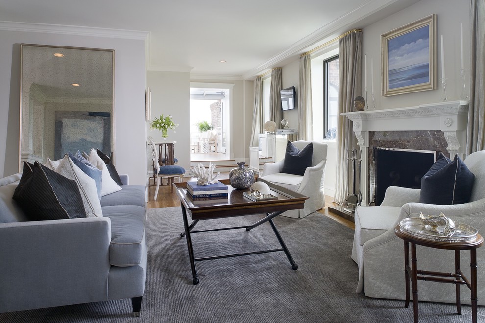 Example of a mid-sized transitional formal and enclosed medium tone wood floor living room design in New York with gray walls, a standard fireplace, a stone fireplace and no tv