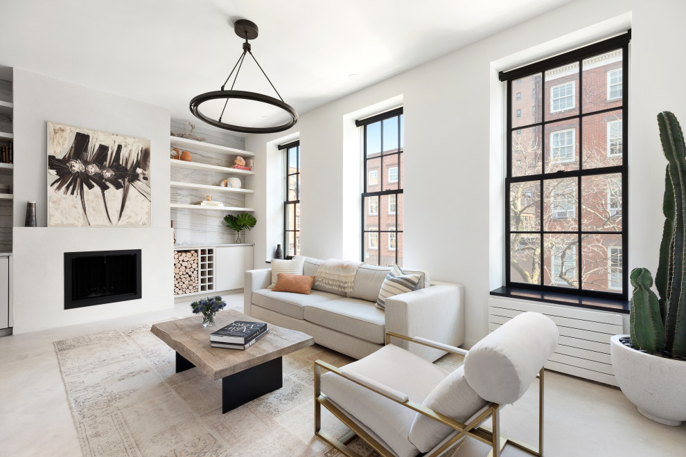 Inspiration for a small contemporary open concept concrete floor and beige floor living room remodel in New York with white walls, a standard fireplace and a plaster fireplace