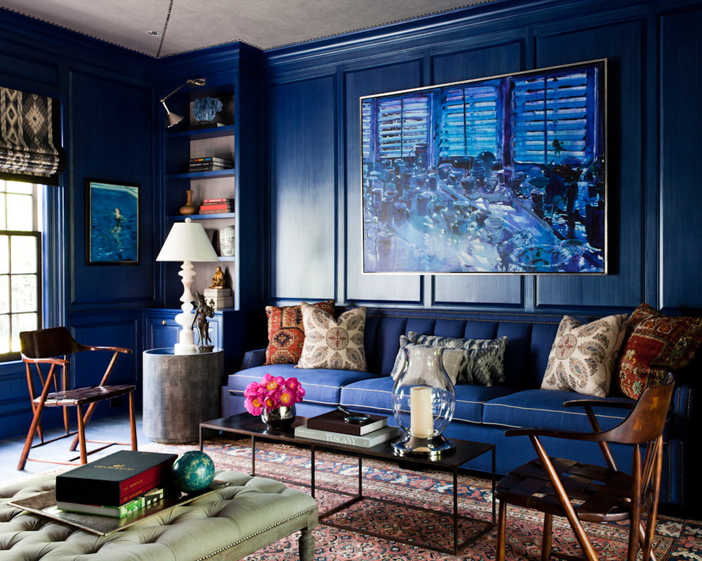 Eclectic formal living room in New York with blue walls.