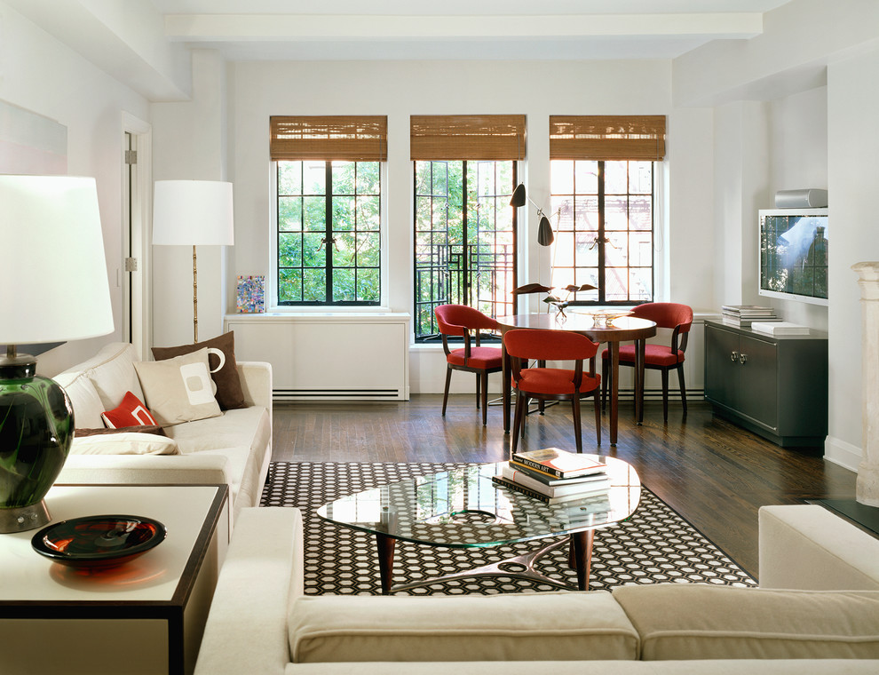 Traditional living room in New York with white walls and dark hardwood flooring.