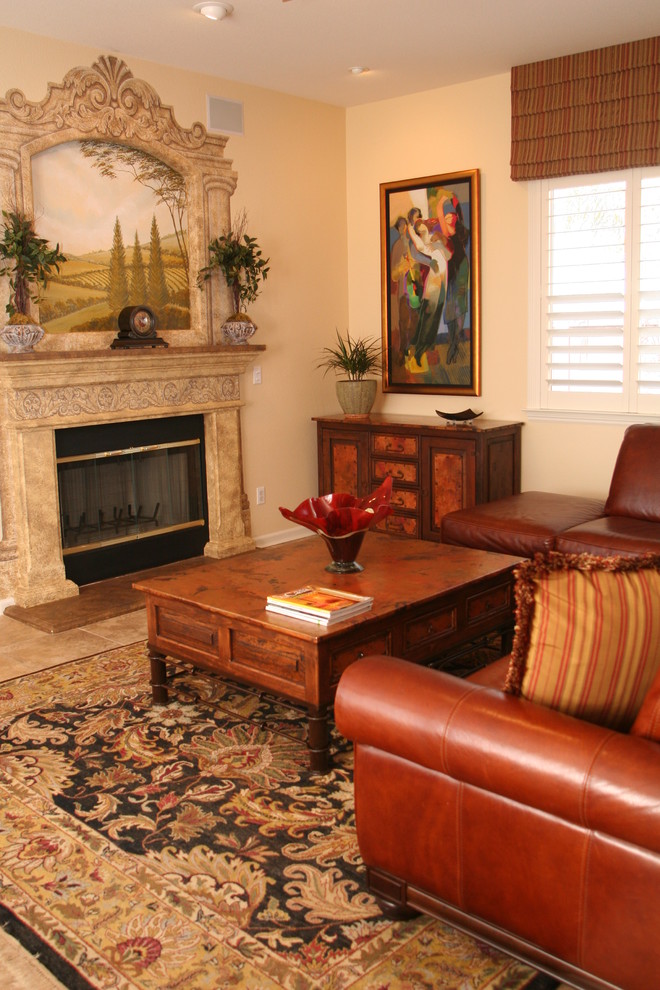 Example of a tuscan living room design in San Francisco with beige walls and a standard fireplace