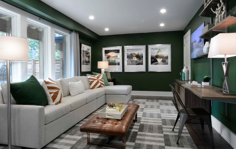 This is an example of a modern living room in DC Metro with green walls and a wall mounted tv.