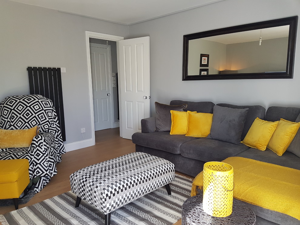 Small contemporary living room in Hertfordshire with grey walls and laminate floors.