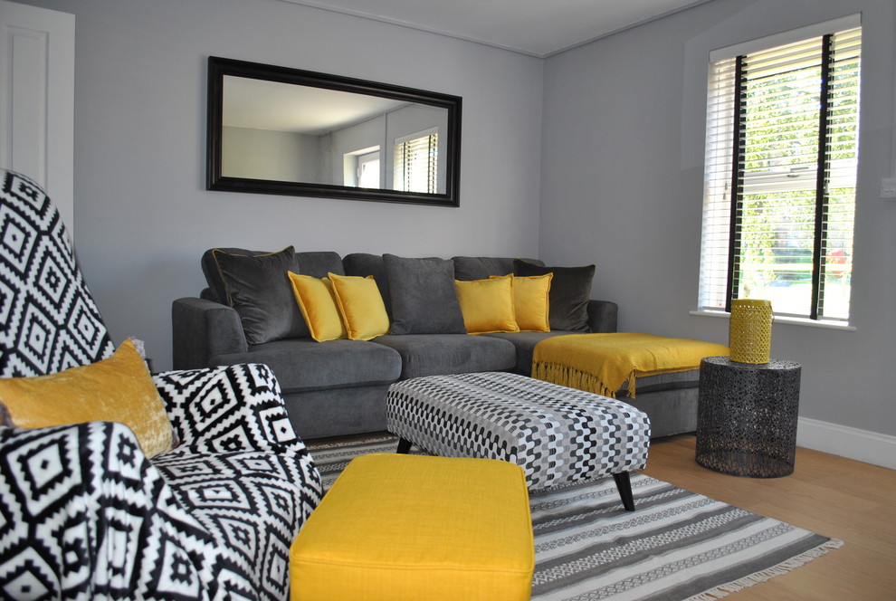 This is an example of a small contemporary living room in Hertfordshire with grey walls and laminate floors.