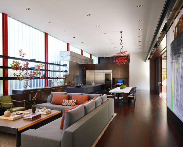 This is an example of a large contemporary open plan living room in Chicago with dark hardwood flooring, a ribbon fireplace and a concrete fireplace surround.