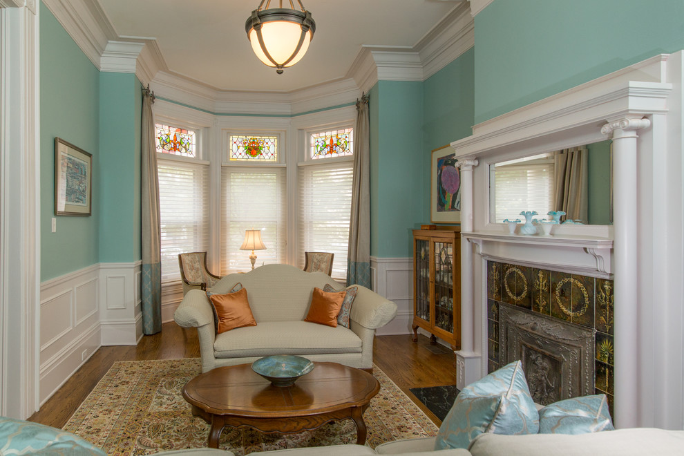 Example of a large ornate formal and enclosed medium tone wood floor and brown floor living room design in Richmond with blue walls, a standard fireplace, a tile fireplace and no tv