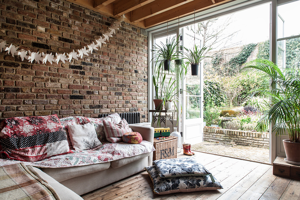 Bohemian enclosed living room in London with light hardwood flooring.