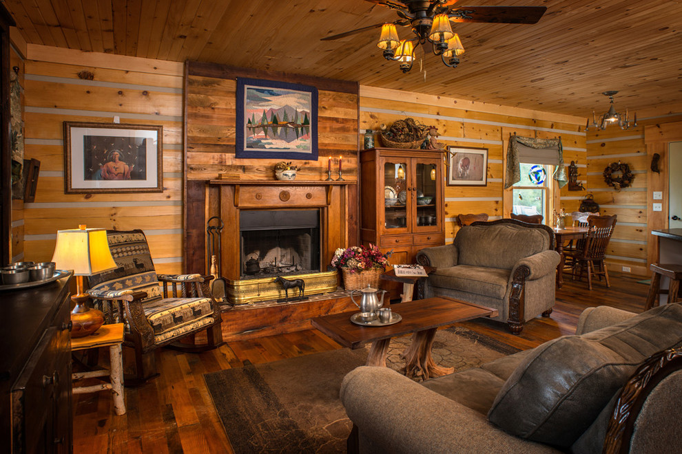 Photo of a medium sized rustic formal enclosed living room in Huntington with multi-coloured walls, dark hardwood flooring, a standard fireplace, a wooden fireplace surround and no tv.