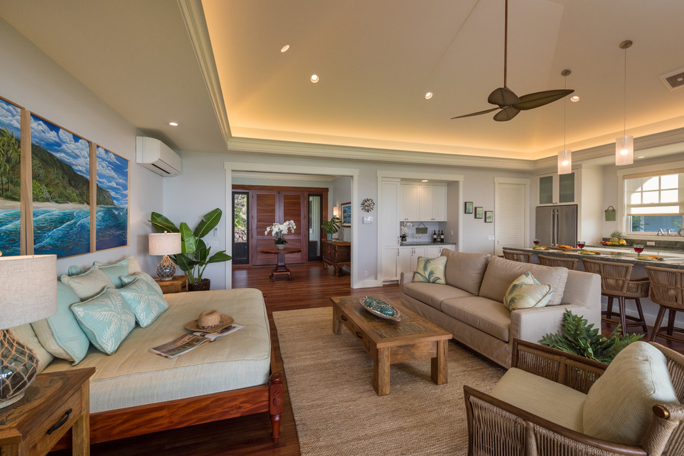 Photo of a beach style open plan living room in Hawaii with white walls, vinyl flooring, a wall mounted tv and brown floors.