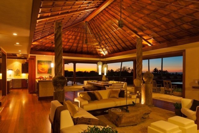 This is an example of a large world-inspired open plan living room in Hawaii with beige walls, medium hardwood flooring, no fireplace and no tv.