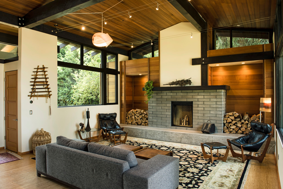 Living room - mid-sized contemporary formal and open concept medium tone wood floor living room idea in Portland with white walls, a standard fireplace, no tv and a brick fireplace