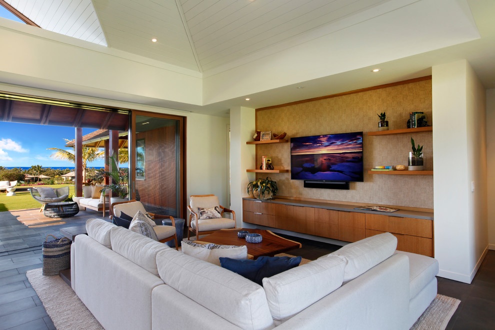 Inspiration for a medium sized world-inspired enclosed living room in Hawaii with white walls, a built-in media unit and grey floors.