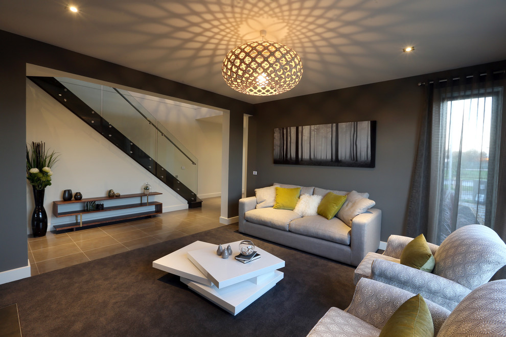 Immagine di un soggiorno minimalista con pareti grigie, moquette, camino classico, cornice del camino in metallo e parete attrezzata