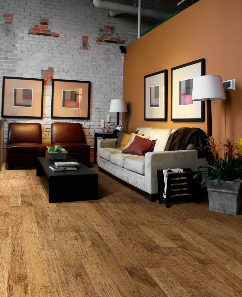 Living room - large modern open concept medium tone wood floor living room idea in Tampa with orange walls