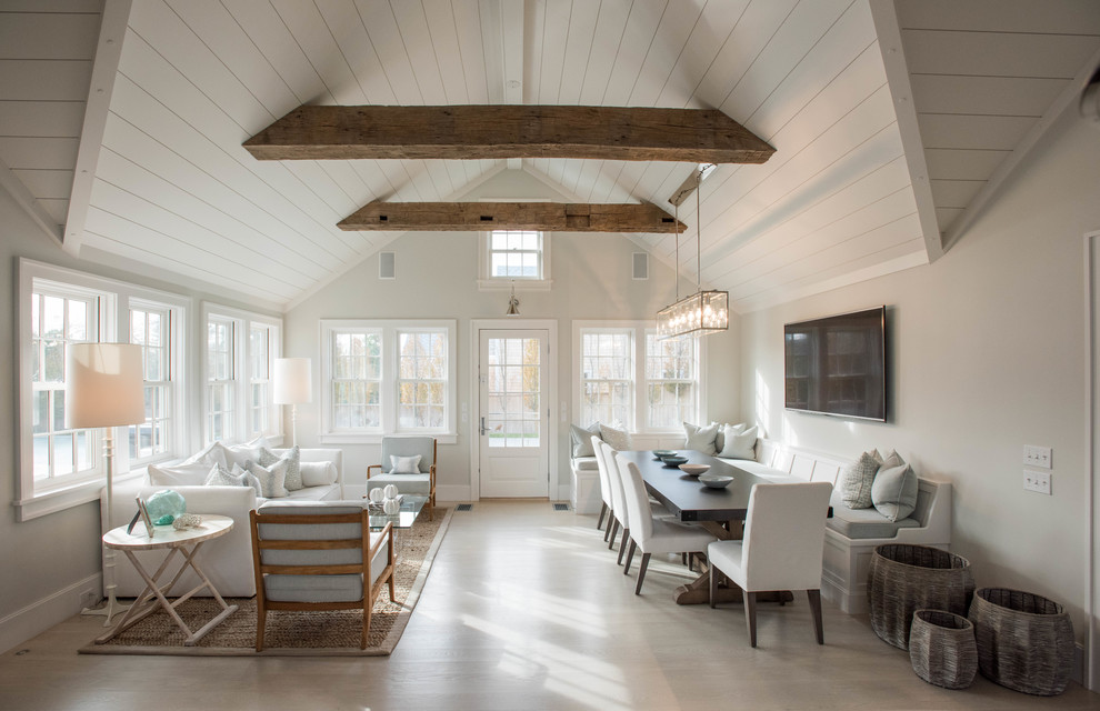 Inspiration for a coastal living room in Boston with white walls and feature lighting.