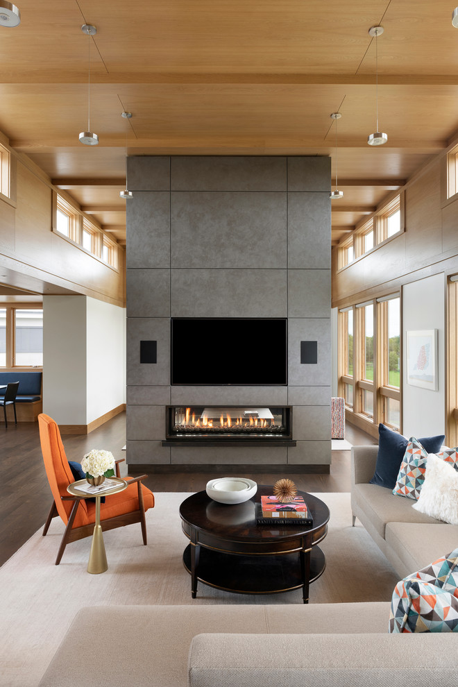 Photo of a large traditional formal open plan living room in Minneapolis with medium hardwood flooring, a standard fireplace, a plastered fireplace surround and a wall mounted tv.