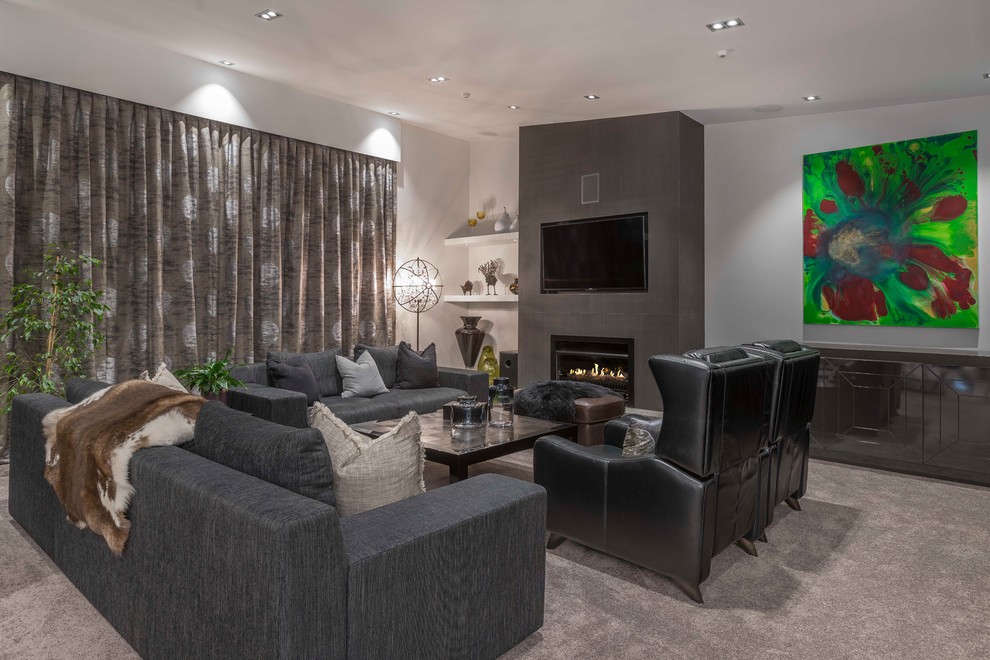 This is an example of a large modern open plan living room in Hamilton with carpet, a wall mounted tv, brown floors, grey walls and a tiled fireplace surround.