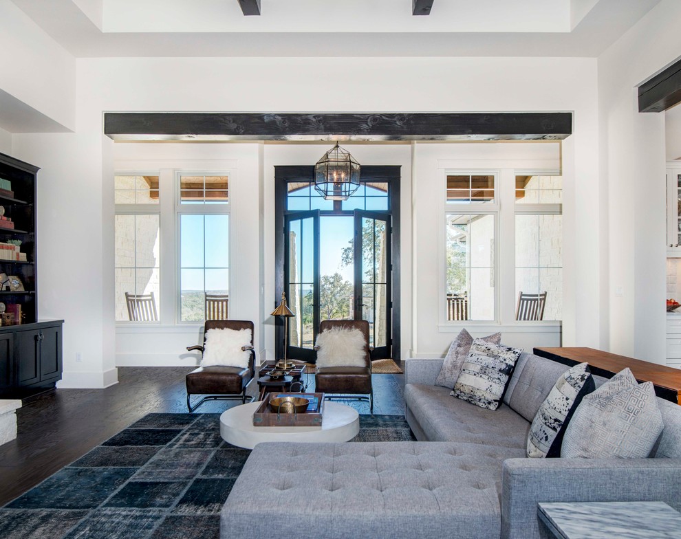 Inspiration for a traditional open plan living room in Austin with white walls and dark hardwood flooring.