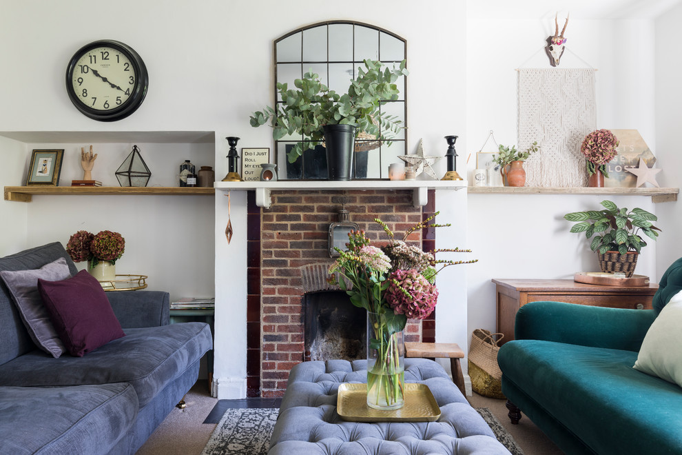 Photo of an eclectic living room in London with white walls, carpet and grey floors.