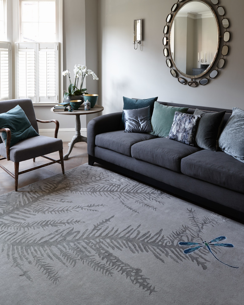 Photo of a contemporary formal and grey and teal enclosed living room in London with grey walls and medium hardwood flooring.