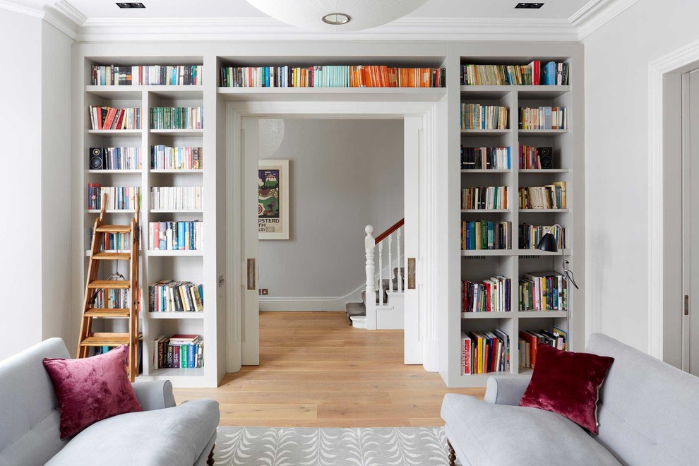 This is an example of a medium sized classic formal open plan living room in London with grey walls, light hardwood flooring and no tv.