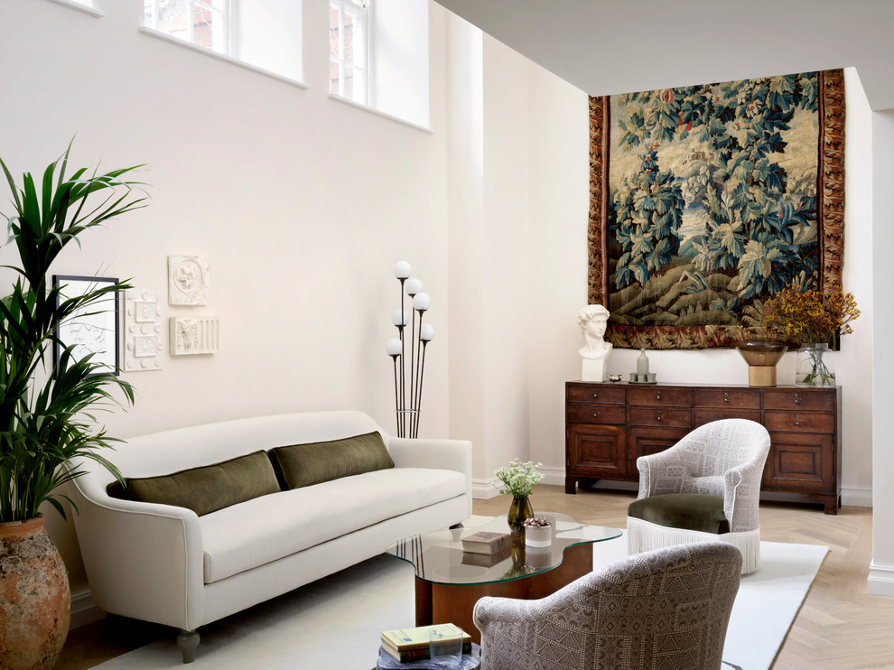 Photo of an eclectic formal living room in London with white walls, light hardwood flooring and beige floors.