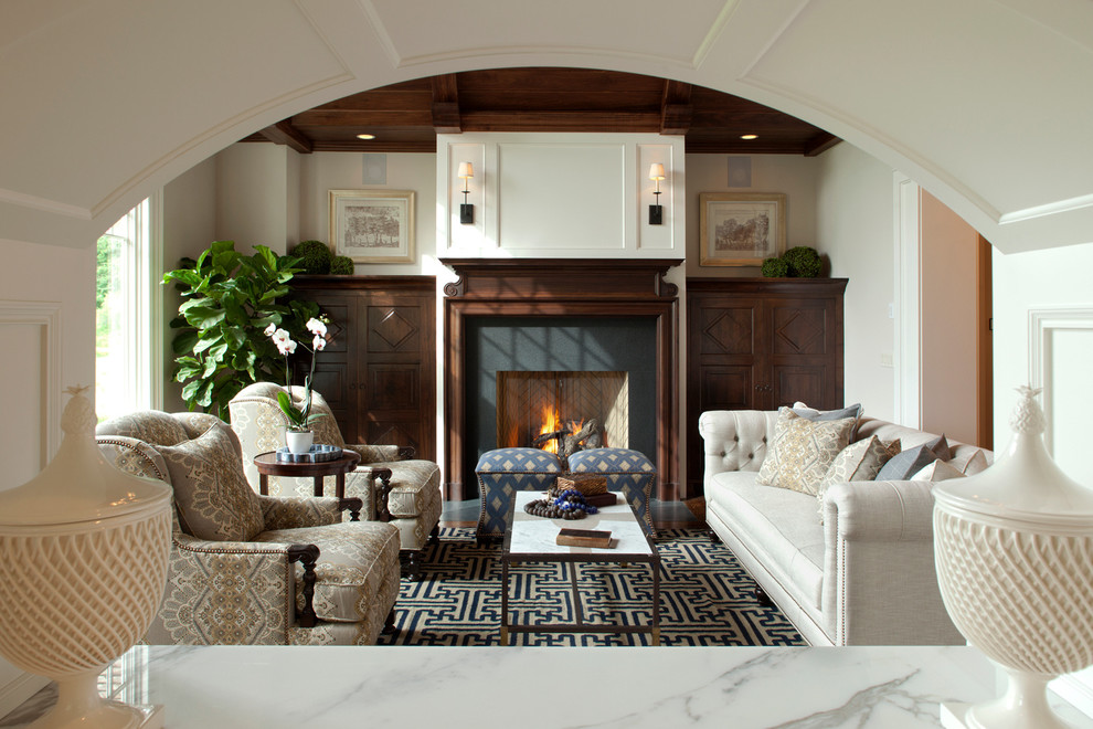 Inspiration for a medium sized classic formal living room in Minneapolis with beige walls, dark hardwood flooring, a standard fireplace, a stone fireplace surround and no tv.
