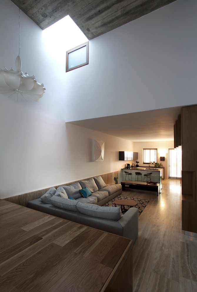 Photo of a contemporary open plan living room in Other with white walls.