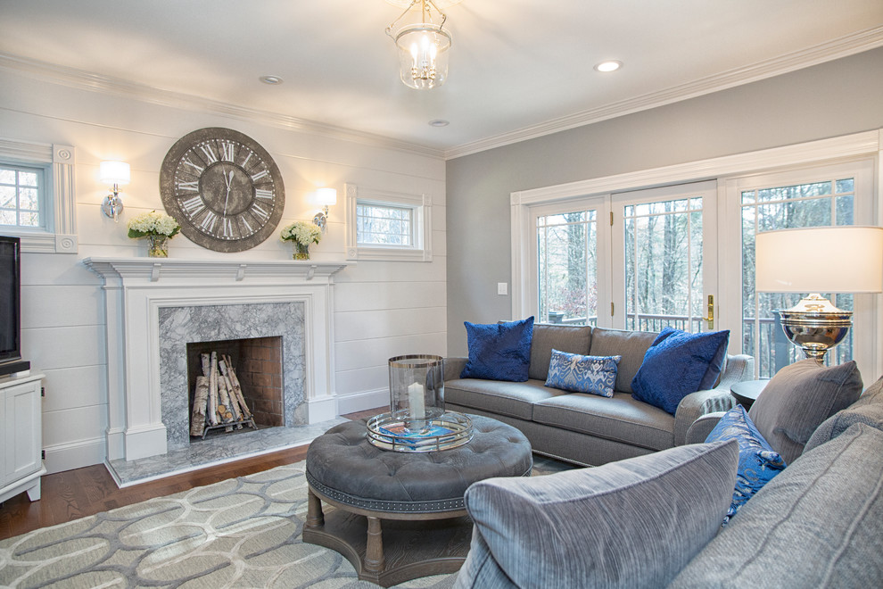 Inspiration for a medium sized traditional open plan living room in Boston with grey walls, a stone fireplace surround, a freestanding tv, medium hardwood flooring, a standard fireplace and brown floors.