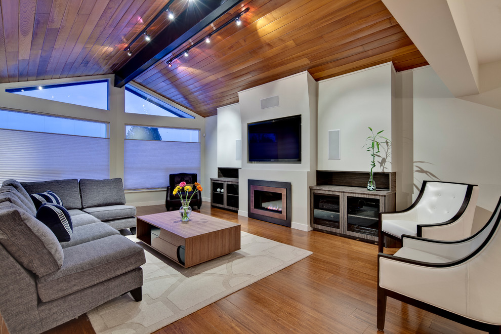Living room - large contemporary formal and open concept medium tone wood floor living room idea in Vancouver with white walls, a wall-mounted tv, a standard fireplace and a metal fireplace