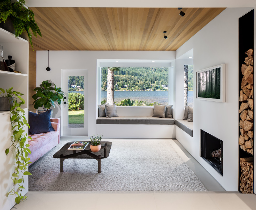 Exemple d'un salon tendance en bois fermé avec un mur blanc, sol en béton ciré, une cheminée standard, un téléviseur fixé au mur, un sol gris et un plafond en bois.