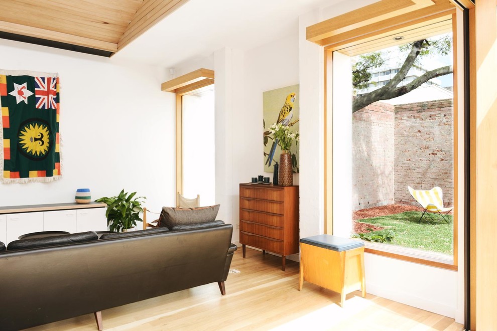Пример оригинального дизайна: парадная, открытая гостиная комната среднего размера в скандинавском стиле с белыми стенами, светлым паркетным полом и фасадом камина из дерева без камина, телевизора