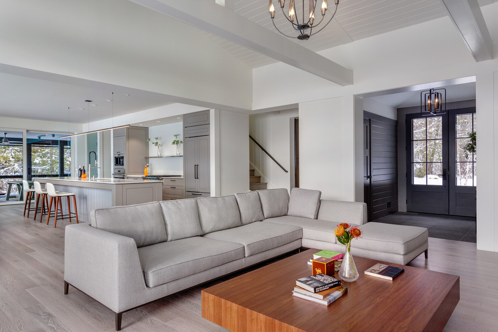 Medium sized contemporary open plan living room in Bridgeport with white walls, light hardwood flooring and grey floors.