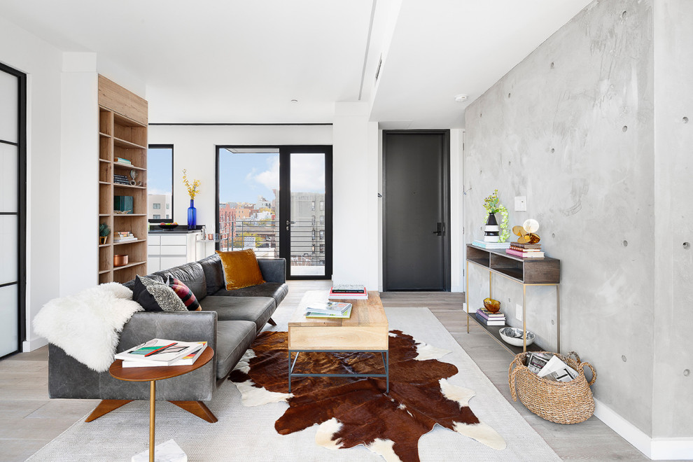 Photo of a contemporary living room in New York with grey walls, light hardwood flooring and grey floors.