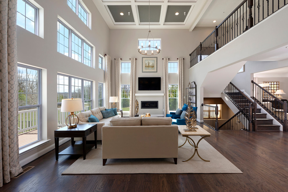 Photo of a classic open plan living room in Baltimore with grey walls, dark hardwood flooring, a standard fireplace, a wall mounted tv and brown floors.