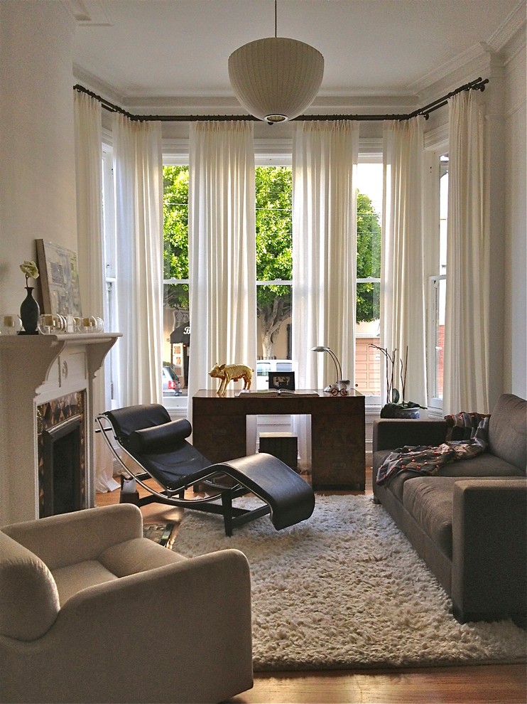 Inspiration for a small eclectic living room remodel in San Francisco with beige walls and a standard fireplace