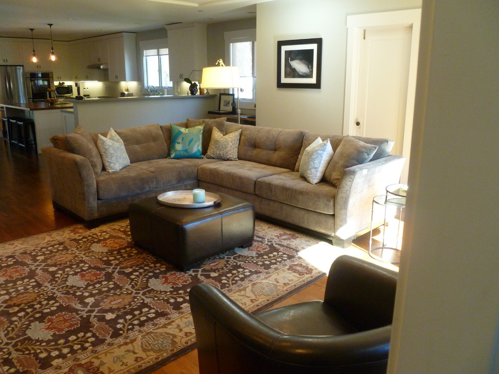 Example of a large eclectic open concept medium tone wood floor living room design in San Francisco with green walls and a tv stand