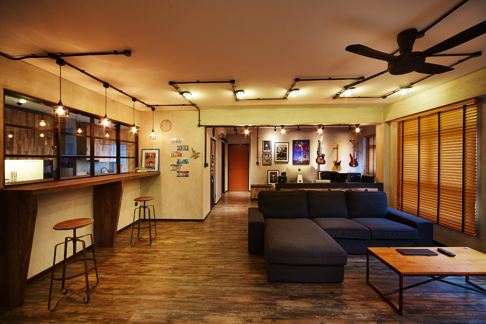 Imagen de salón abierto urbano de tamaño medio con paredes grises y suelo de madera oscura