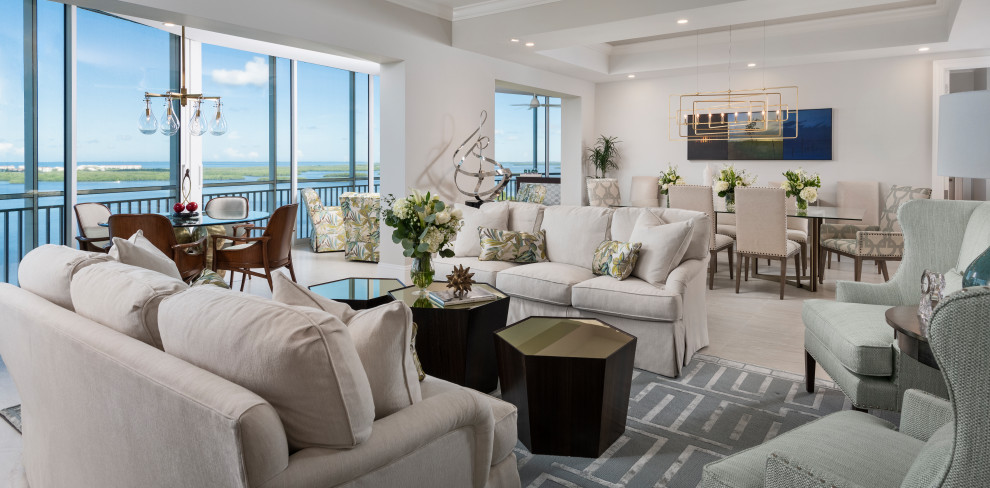 This is an example of a large coastal open plan living room in Other with beige walls, porcelain flooring and beige floors.