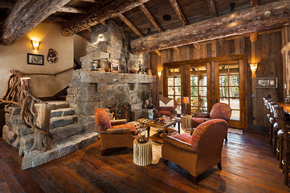 Foto de salón abierto rural de tamaño medio sin televisor con suelo de madera oscura, todas las chimeneas y marco de chimenea de piedra