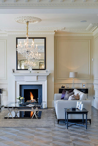 Inspiration for a large contemporary formal enclosed living room in London with beige walls, medium hardwood flooring, a standard fireplace, a stone fireplace surround and no tv.