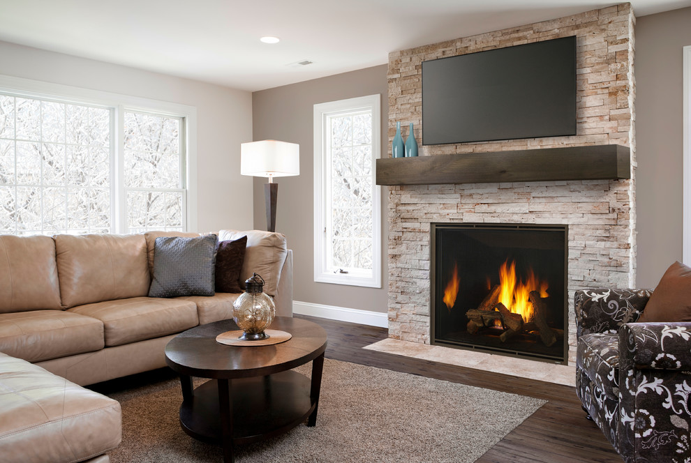 Large trendy open concept dark wood floor and brown floor living room photo in Boston with brown walls, a standard fireplace, a stone fireplace and a wall-mounted tv