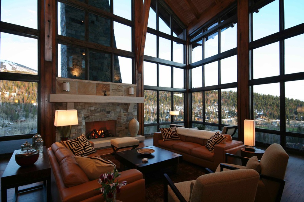 Photo of an expansive contemporary open plan living room in Denver with beige walls, medium hardwood flooring, a standard fireplace and a stone fireplace surround.