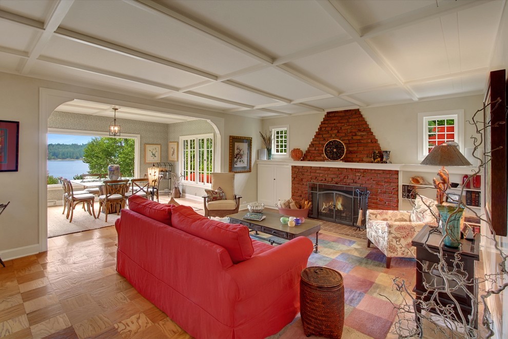 This is an example of a rural living room in Seattle with beige walls, a standard fireplace and a brick fireplace surround.