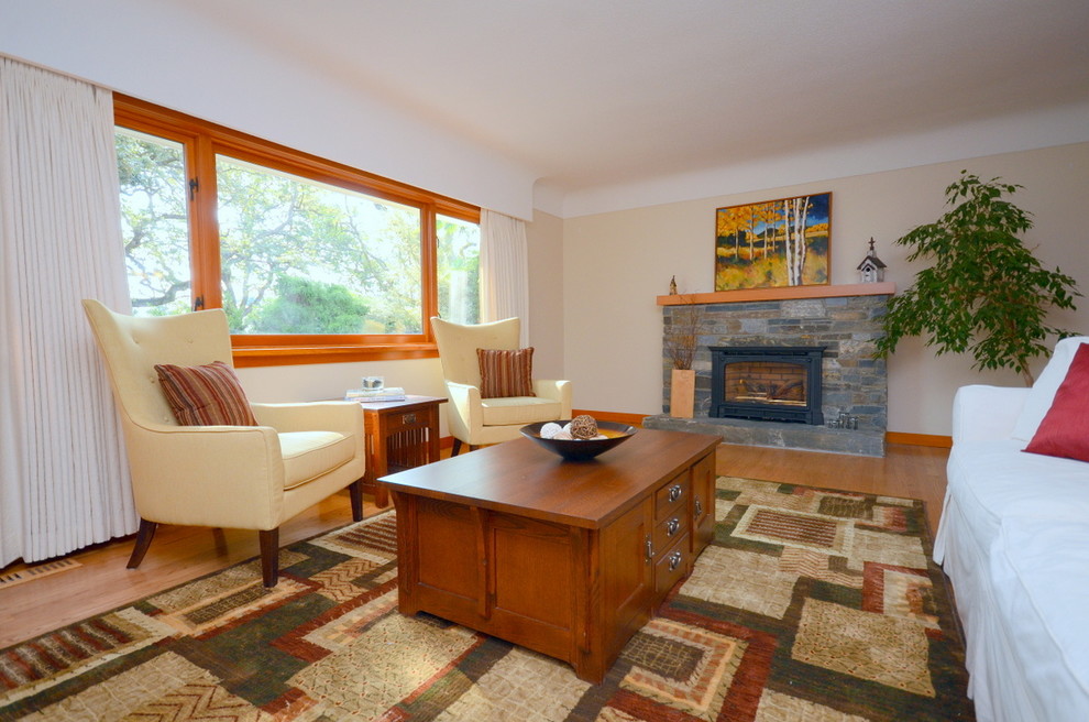 Photo of a small classic open plan living room in Vancouver with a home bar, white walls and light hardwood flooring.