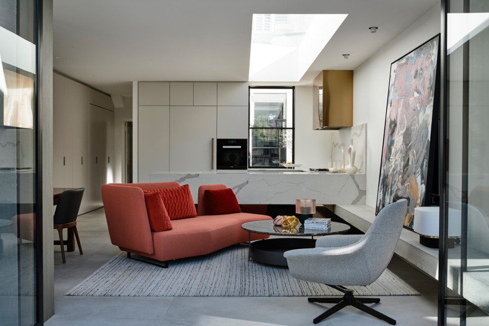 This is an example of a contemporary open plan living room in Melbourne with white walls, porcelain flooring, no fireplace, a wall mounted tv and grey floors.