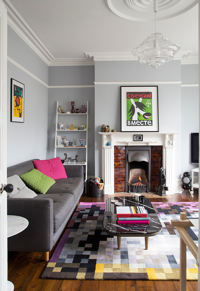 Mid-sized transitional enclosed dark wood floor living room photo in London with a standard fireplace, blue walls and a tile fireplace